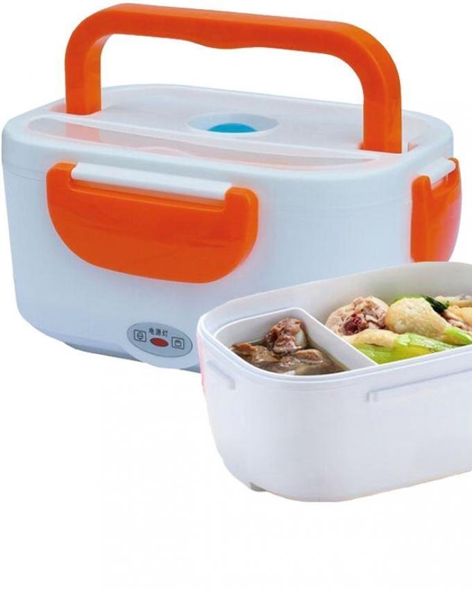 Electric lunch box with orange handle and compartments holding cooked chicken and vegetables